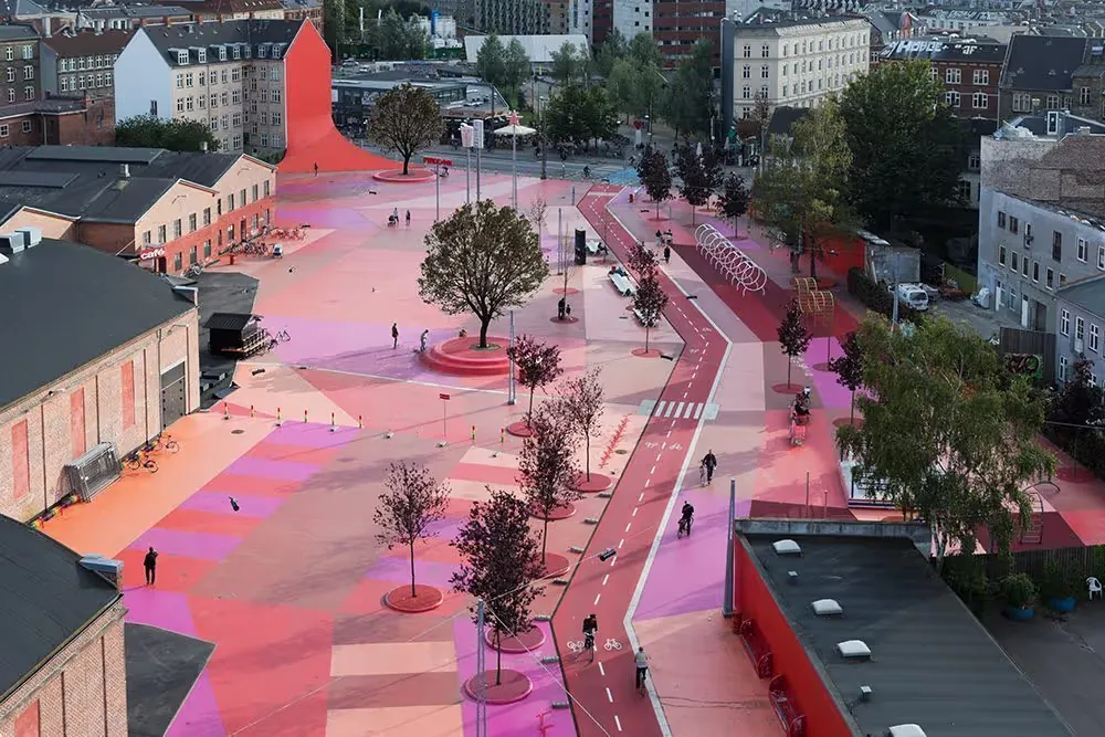 A city street with a red bike path.