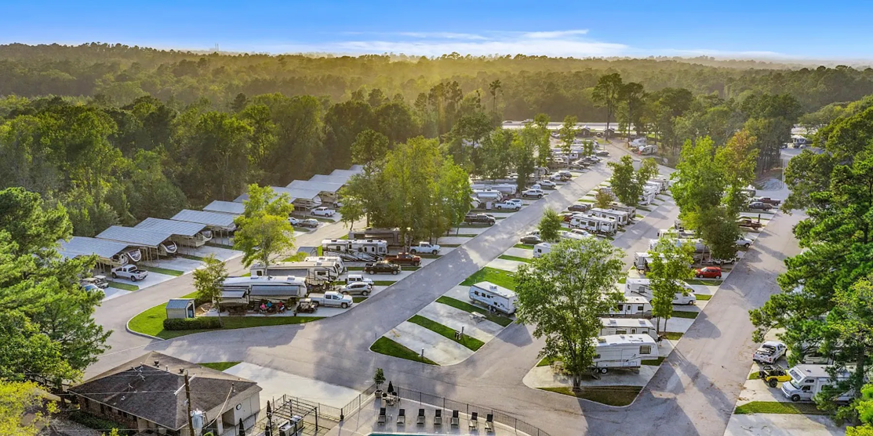 RV park surrounded by lush greenery at sunrise